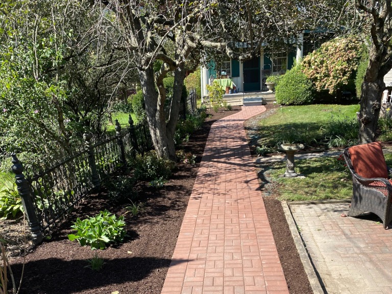 A brick sidewalk through a customer's front yard